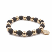 Load image into Gallery viewer, The Luxor Geode Beaded Bracelet in Black and Gold is comprised of geode pocks on the surface of stone beads. Geodes are known to have hollow cavities lined with crystals. Silver frost mark the perimeter of this piece to give it the perfect druzy shine. Try stacking these with other bracelets to really bring it all together. Exclusively from Kinsley Armelle.   Details:  Style: Beaded Material: Agate + Metal Size: 6.5 - 8 Inch Circumference
