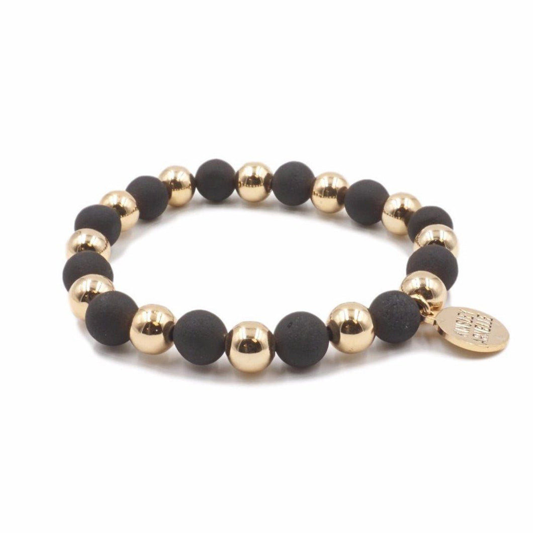 The Luxor Geode Beaded Bracelet in Black and Gold is comprised of geode pocks on the surface of stone beads. Geodes are known to have hollow cavities lined with crystals. Silver frost mark the perimeter of this piece to give it the perfect druzy shine. Try stacking these with other bracelets to really bring it all together. Exclusively from Kinsley Armelle.   Details:  Style: Beaded Material: Agate + Metal Size: 6.5 - 8 Inch Circumference