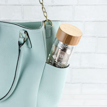 Load image into Gallery viewer, Take tea time anywhere with this chic portable infusing glass bottle. This double-walled 16 oz. botte keeps drinks at the perfect temperature while staying cool to the touch.  It includes a detachable strainer and infuser for loose-leaf tea.  Material:  Double-walled borosilicate glass, stainless steel, bamboo, &amp; silicone Capacity: Holds 16 oz Care: Handwash only   Includes: Detachable infuser Infuse tea on-the-go Exterior wall stays cool to the touch and keeps contents hot or cold longer
