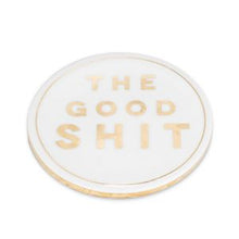 Load image into Gallery viewer, Your guests won’t have to wonder what you’re serving them with this cheeky “The Good Shit” Coaster. Crafted out of ceramic and cork with elegant gold lettering, this coaster will definitely make your guests feel like they’re the privileged few.  Size:  4&quot; Diameter Material:  Ceramic/Cork Colour:  White/Gold 
