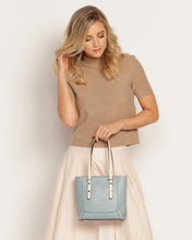 Load image into Gallery viewer, Small, sweet and on-trend!  This gorgeous Pale Blue Hazel Handbag screams Audrey Hepburn!!  Such a classic style and easy to carry, this perfectly sized handbag has more than enough room for all your essentials.  Features:  1 x Phone Pocket 1 Flat Pocket Feet on base Internal lining Strap Height: 20cm Extension strap: 110cm Adjustable Detachable Closure: Secure Zip Material: Vegan Leather  Hardware: Light Gold  Dimensions: W22 x H21 x D8 cm
