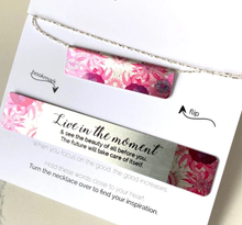 Load image into Gallery viewer, This beautiful SILVER and FUSHIA PINK FLORAL set includes:  (1) Bar Necklace (can be worn either way) - Quote on back : &quot;live in the moment&quot; (1) Bookmark - Quote: &quot;Live in the moment &amp; see the beauty of all before you.  The future will take care of itself.&quot; 18&quot; adjustable silver chain.  Crafted from upcycled trophy aluminum.  Each piece is eco-friendly, hypo-allergenic, lead and nickel free.
