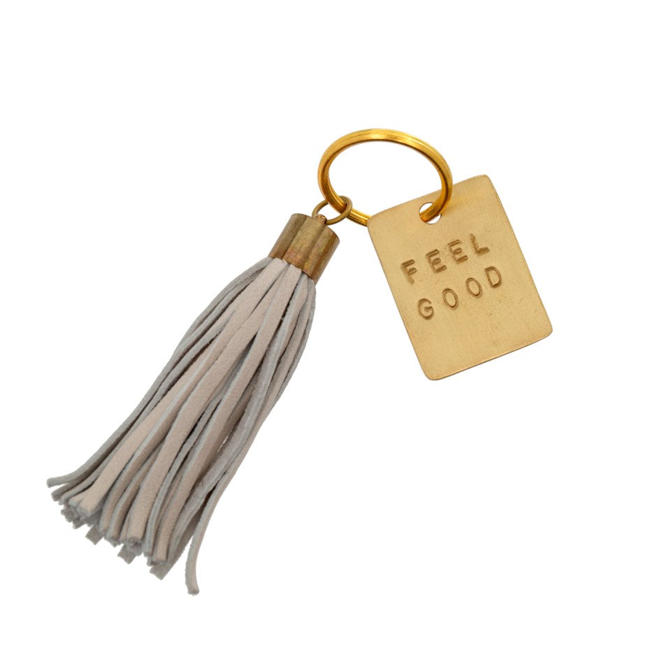 Why not remind yourself to Feel Good everyday!  You are unique and your accessories should be too!  This chic Leather Tassel Keychain will perfectly adorn your keys, and its stylish enough to give your purse a special added touch.  Materials:   Leather Tassel Brass Plate: 1.25