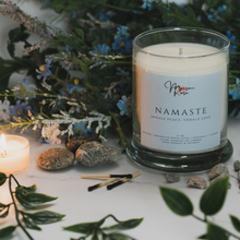 Load image into Gallery viewer, Relax and center yourself when feeling out of balance with the Namaste Candle. Key Ingredients: Incense, Indonesian White Copal, Patchouli, Champa Aroma: Smokey, Aromatic, Herbal Type of Product: Hand-poured soy candle Size: 10 oz Burning Time: 60+ hours Made With: A natural soy wax A natural wax coated cotton wick for fast fragrance release Premium scented candles Paraffin-free, phthalate-free essential and fragrance oils, 100% vegan, Packaged in a reusable apothecary jar with a rose gold lid
