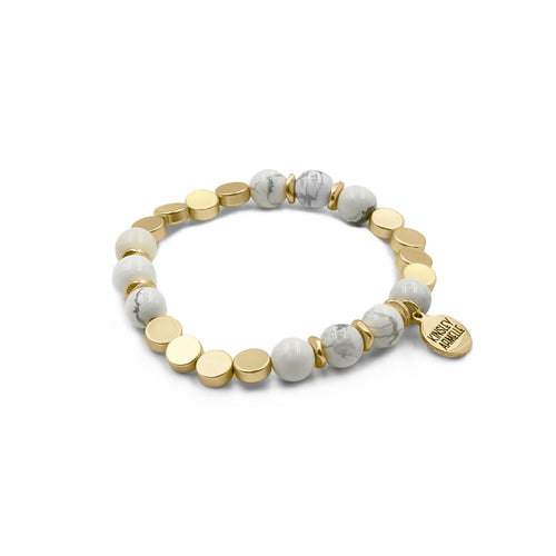 The Pepper Amari Beaded Bracelet is comprised of White Howlite stone beads spaced evenly with decorative gold flat disc embellishments. The Pepper Amari is perfect on its own, but it also completes the look of, and exquisitely complements, the other bracelets featured in the Lennox Stack. Exclusively from Kinsley Armelle.  Details:  Style: Beaded Material: White Howlite and Metal Size: 6.5 - 8 Inch Circumference