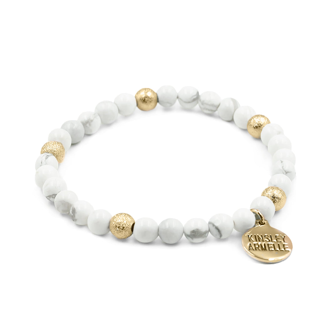 The Pepper Keystone Beaded Bracelet is an absolute no-brainer when creating the perfect stack. It is featured as part of the Lennox Stack. The stone color on this bracelet is sure to grab attention, but subtle enough to wear with any outfit! Exclusively from Kinsley Armelle.  Details:  Style: Beaded Material: White Howlite and Metal Size: 6.5 - 8 Inch Circumference