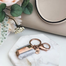 Load image into Gallery viewer, This Quartz Bangle Keychain features dual raw quartz stones on a smooth rose gold ion-plated stainless steel pendant. The stones are rigid rocks to add that extra flare to your style. Exclusively from Kinsley Armelle.   Details:  Material: 18K Rose Gold Ion Plated Stainless Steel Size: 3 Inch Long
