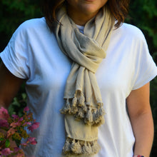 Load image into Gallery viewer, This beautifully hand-embroidered scarf is all about the details.  With its soft stonewashed colour, unique paisley daisy chain edging and thick tassel ends, it&#39;s a sophisticated accessory you can either dress up or down.  Perfect for walks along the beach or strolling through shops in your favourite little town.  Materials: 100% Rayon Dimensions: 80&quot;L x 26&quot;W Shown: Person wearing Madalenna Scarf
