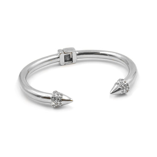 The Bling Spike Metal Cuff Bracelet features a hinge open bangle with spiked points encased in rhinestones. The spikes are bound to draw attention and add that extra flare to your stack or outfit for the night. Try stacking these bracelets to really make everyone notice your style. Exclusively from Kinsley Armelle.   Details:  Style: Cuff Material: Silver Ion Plated Stainless Steel Size: 6.5 - 8 Inch Circumference