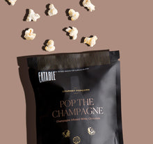 Load image into Gallery viewer, Pop The Champagne Infused Gourmet Popcorn (40 gram bag) by EATABLE.  Kettle popped whole grain popcorn coated in a smooth, premium Belgian white chocolate. Sprinkled with Champagne-infused sugar crystals that literally &quot;pop&quot; in your mouth for an unforgettable sensory-filled snacking experience!  Makes a great addition to any gift set creation.  Also a perfect travel size for a quick car or plane snack on the go.  **Due to the nature of the product, this item is NON-REFUNDABLE
