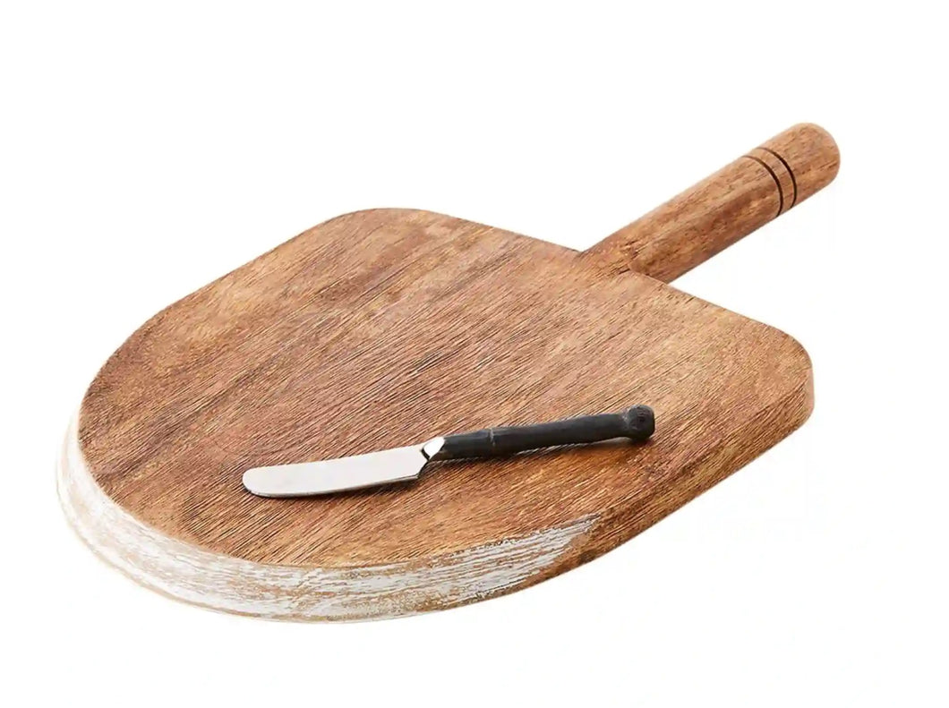 Serve up your favourite cheeses and bread with this gorgeous Mango Wood Paddle Serving Board Set.  The paddle board features a cut edge detail and will definitely compliment any table. Makes a great hostess, bridal shower or seasonal gift. Set Includes: (1) Mango Wood Board (1) Cast Iron Handle Spreader Size:  Board - 14.25 x 9