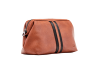 Load image into Gallery viewer, The Gilbert Men’s Toiletry Case is the perfect men’s travel accessory. Designed to fit his toiletries with ease and constructed with quality vegan leather, it is an ideal gift for the men in your life. 2 Colours to choose from: Black Tan Pair it with the Sinatra Toiletry Case for a set that has him covered! Internal features: 1 Zip Pocket Lining: Nylon Closure: Secure Zip Material: Vegan Leather Hardware: Gun Metal Dimensions: W25.5 x H16.5 x D9cm. Shown: Tan
