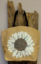 Load image into Gallery viewer, Make a statement this summer on daytime trips or holiday adventures with our beautiful burlap beach tote.  This spacious bag has ample room for all of your essentials.  Styled with hand-woven terrycloth sunflower motifs, this beach bag provides functionality while serving a fashionable look to passers by.  This summer beach tote is a must have to venture off to the beach, cottage, boat cruise, picnic or weekend getaway in style!  Material: Burlap  Dimensions: W21&quot; x H18&quot; x D6&quot;
