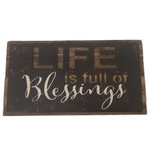 Load image into Gallery viewer, This rustic style painted iron on a wood plaque with inspirational printed &quot;Life Is Full Of Blessings&quot; sentiment is the perfect adornment for any home.  Hang it or set it on any surface in your foyer, kitchen, familyroom or hallway so everyone can see it.  Makes a great hostess, mother&#39;s day or just because gift too.  Size: 7&quot; x 4&quot; x 1.5&quot;  Material: Pine wood/Iron
