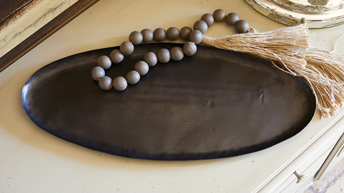 This gorgeous oval tray is our most versatile and sustainable piece yet.  Each one is uniquely designed with recycled iron, giving it a unique finish.  Perfect for any room to enhance your decor. Perfect for entryways, mantels, countertops, kitchen tabletops or coffee tables.  Makes a great hostess or house warming gift.  Add any of our candles, diffusers or beads for a completely sophisticated look.   Size:  19.75