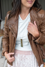 Load image into Gallery viewer, The Caraway necklace has a vintage middle eastern vibrant pattern, with hits of warm green and ochre.  The off centre bend allows for the affirmation word &quot;Strong&quot; to be exposed.  This is the perfect layering necklace with a 30&quot; stainless steel, hypo-allergenic, tarnish free chain and a recycled aluminum pendant.  The pendant measures 3 1/4&quot; long x 3/4&quot; wide. The aluminum makes it light weight for easy wear. Shown: Person wearing necklace.
