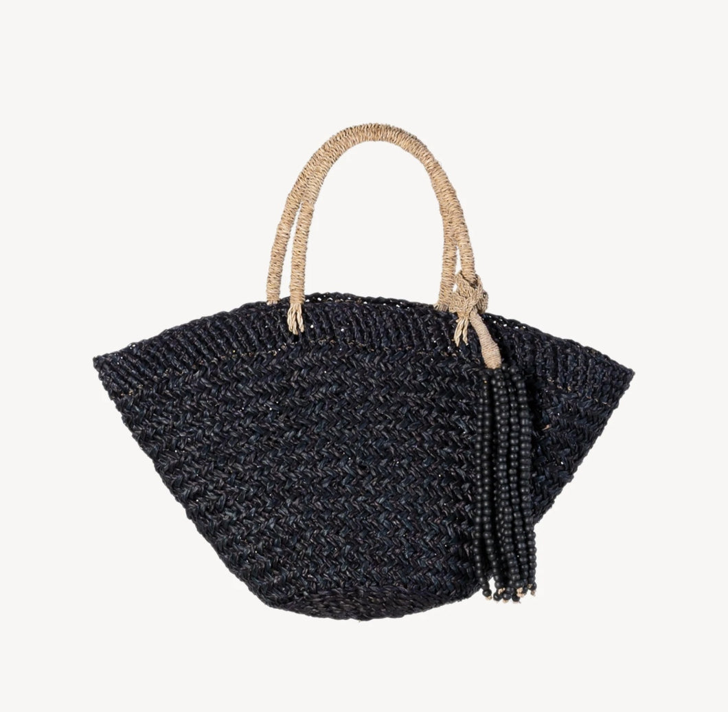 Classic black handbag with its thick handle and high-quality structure. It features a removable tassel made of thick jute rope and wooden beads. Use the tassel as a home accent, a doorknob hanger, a wall hanging, or over another bag.  Hand-woven by independent Balinese artisans in a fair-trade environment, each bag is crafted using sustainably-harvested mendong grass.   Size:  20