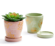 Load image into Gallery viewer, Take your potted plants to the next level with this mini planter styled with an inspirational sentiment and gold accents.  Stunning colours to accent your home decor.  Add a beautiful succulent plant to make a great gift!  Complete with drainage hole and removable tray.  Perfect for Mother&#39;s Day, Birthdays, House Warming or Just Because.  Available in 3 designs:  Green Lotus Pad/GROW WITH LOVE Pink Lotus Flower/THINK HAPPY BE HAPPY Blue Grey Dragonfly/BELIEVE IN TOMORROW.  Size:  3&quot; D  Material:  Ceramic
